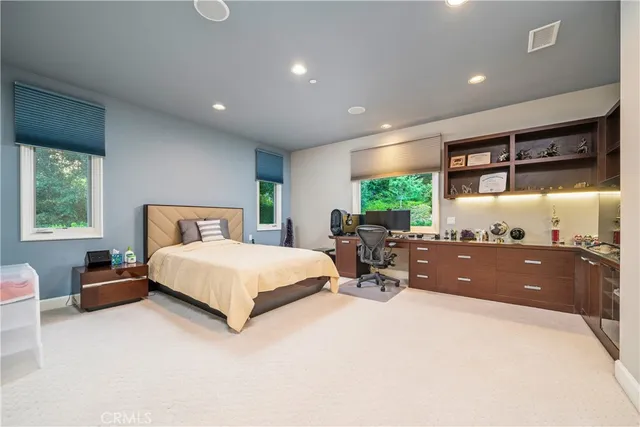 a view of a house with a yard and potted plants