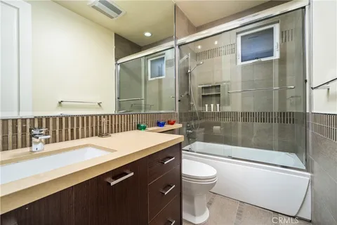 a front view of a house with a yard and potted plants