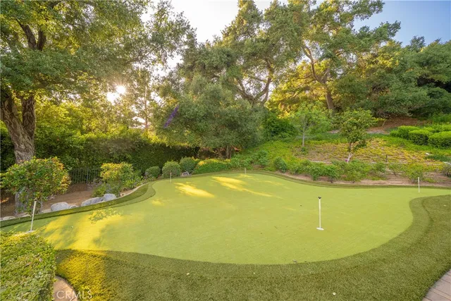 an aerial view of a house with a yard and lake view
