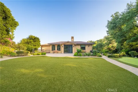 a view of multiple house with yard and trees