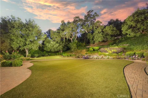 a view of a hallway with wooden floor and windows