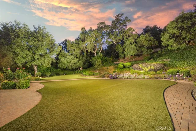 a view of a hallway with wooden floor and windows