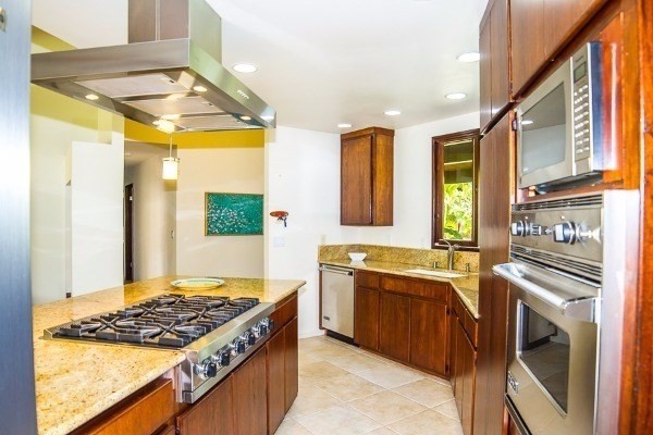 4200 Omao Road Koloa, HI 96756 - Photo 10 of 19 a kitchen with stainless steel appliances granite countertop a stove a sink and a refrigerator