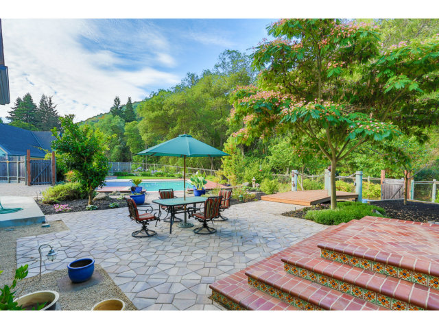 29551 Palomares Road Castro Valley, CA 94552 - Photo 8 of 25 a view of a patio with table and chairs under an umbrella