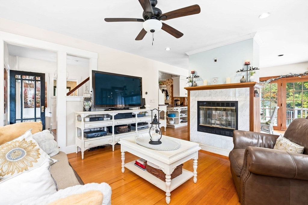 840 Fisher Road Fitchburg, MA 01420 - Photo 9 of 42 a living room with furniture flat screen tv and a fireplace