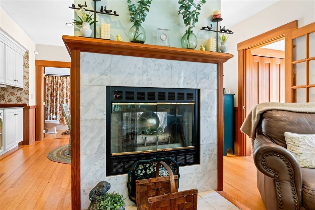 840 Fisher Road Fitchburg, MA 01420 - Photo 10 of 42 a living room with a fireplace and a flat screen tv