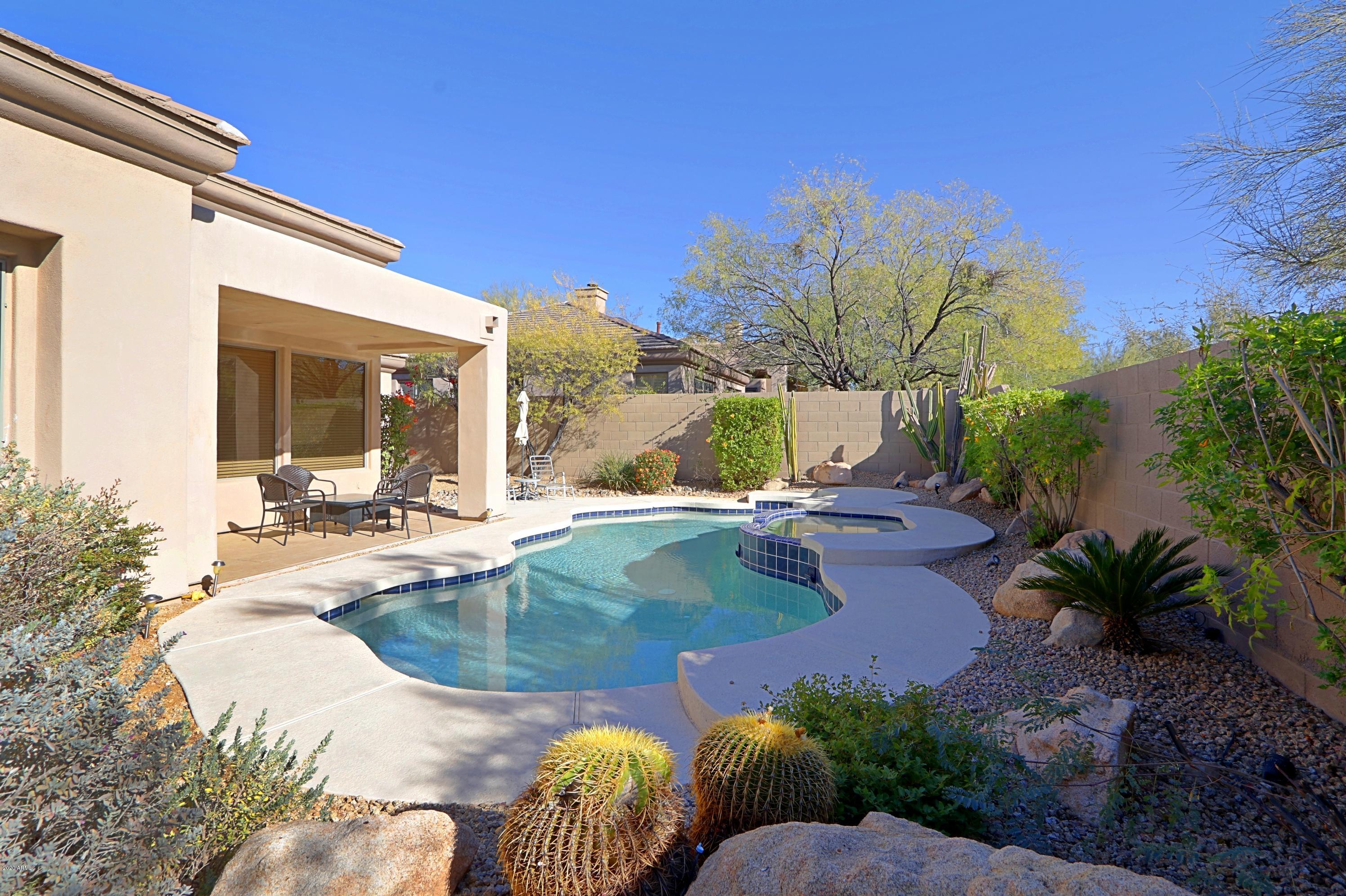 6803 East Eagle Feather Road Scottsdale, AZ 85266 - Photo 31 of 67 a view of swimming pool with outdoor seating and plants