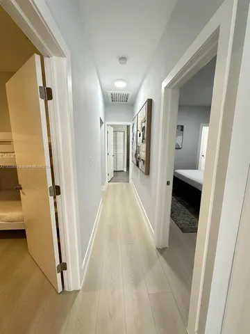 a view of a hallway view with wooden floor and staircase