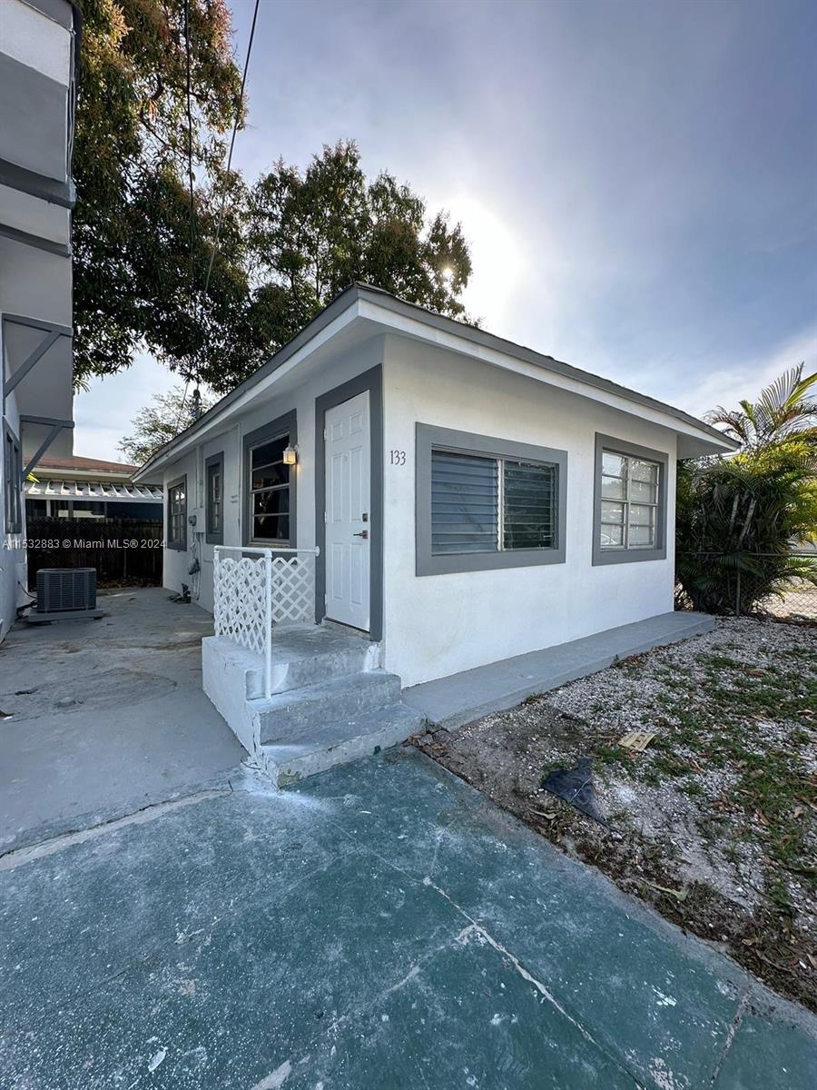 994 Northwest 2nd Street Miami, FL 33128 - Photo 21 of 30 a view of a house with a yard and garage