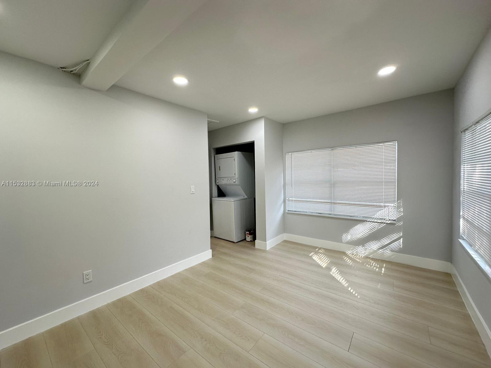 994 Northwest 2nd Street Miami, FL 33128 - Photo 22 of 30 a view of an empty room with wooden floor and a window