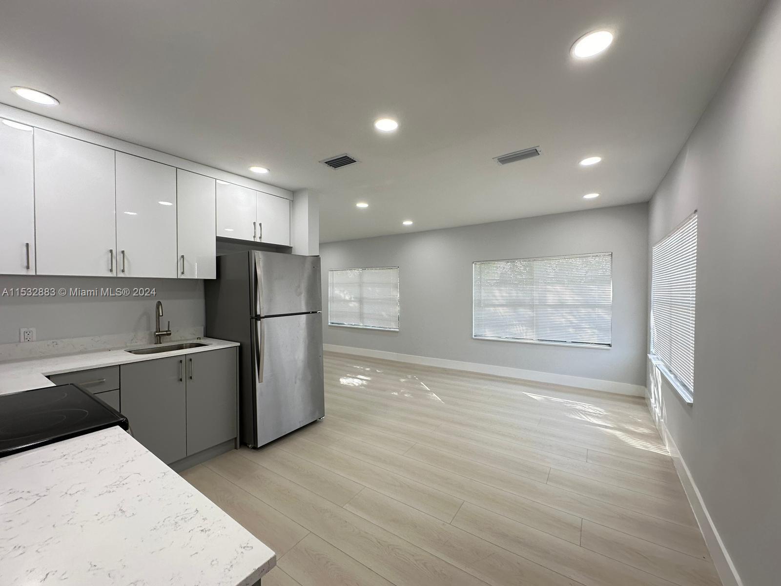 994 Northwest 2nd Street Miami, FL 33128 - Photo 29 of 30 a kitchen with a refrigerator and a sink