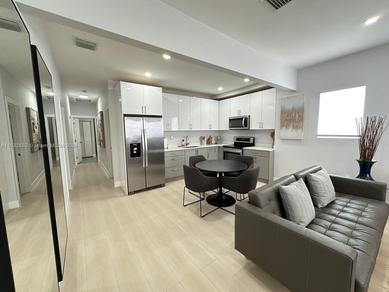 994 Northwest 2nd Street Miami, FL 33128 - Photo 4 of 30 a living room with furniture and a fireplace