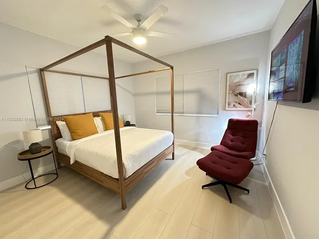 a bedroom with a bed and chair