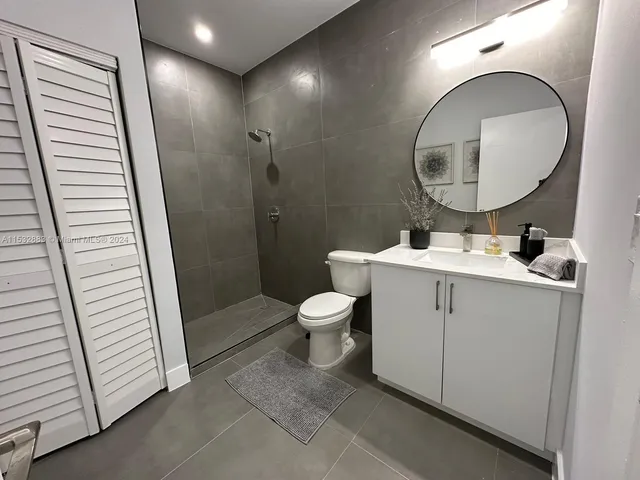 a bathroom with a toilet a sink and a mirror