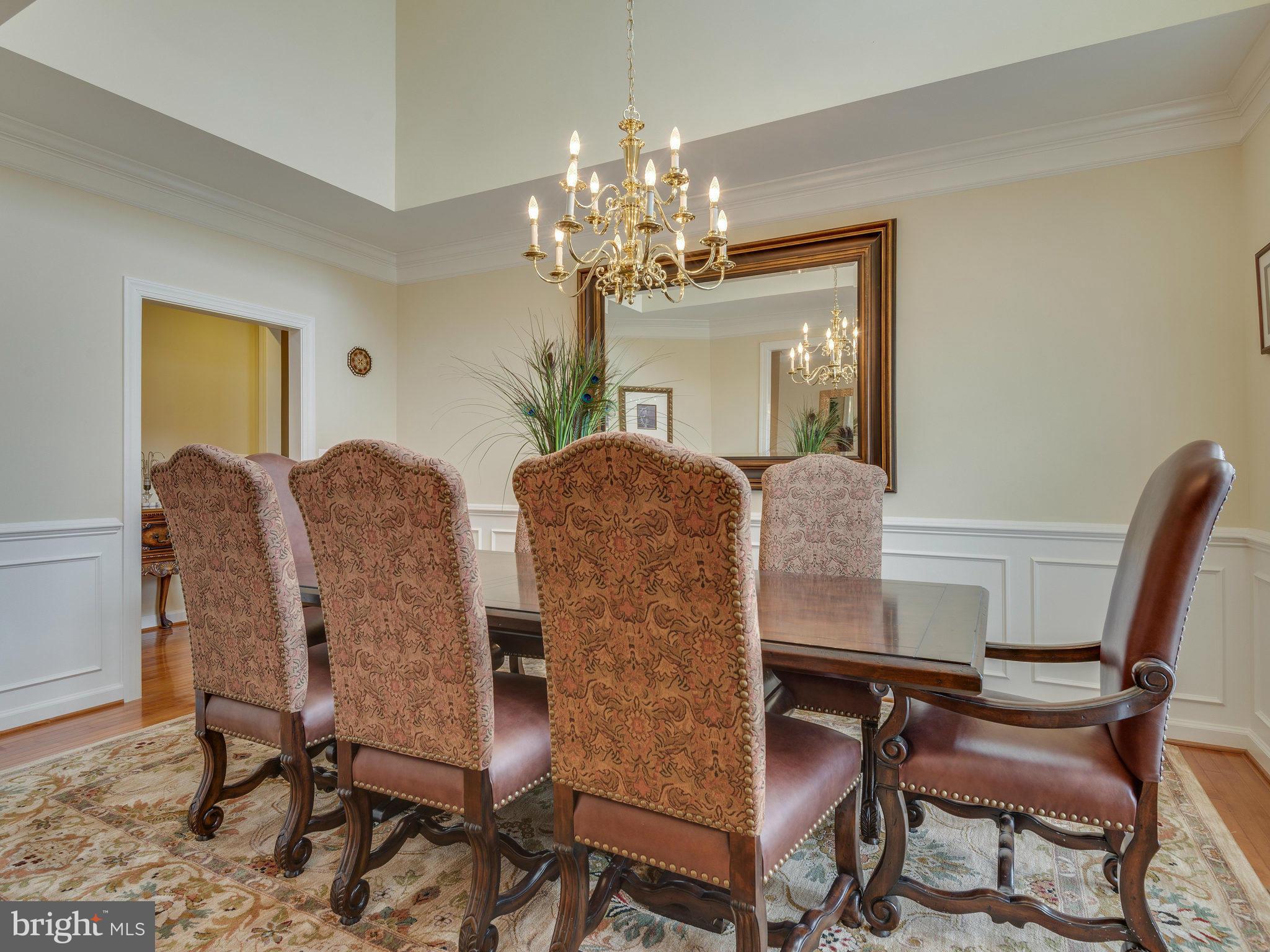22570 Forest Manor Drive Ashburn, VA 20148 - Photo 11 of 30 a view of a dining room with furniture and a chandelier