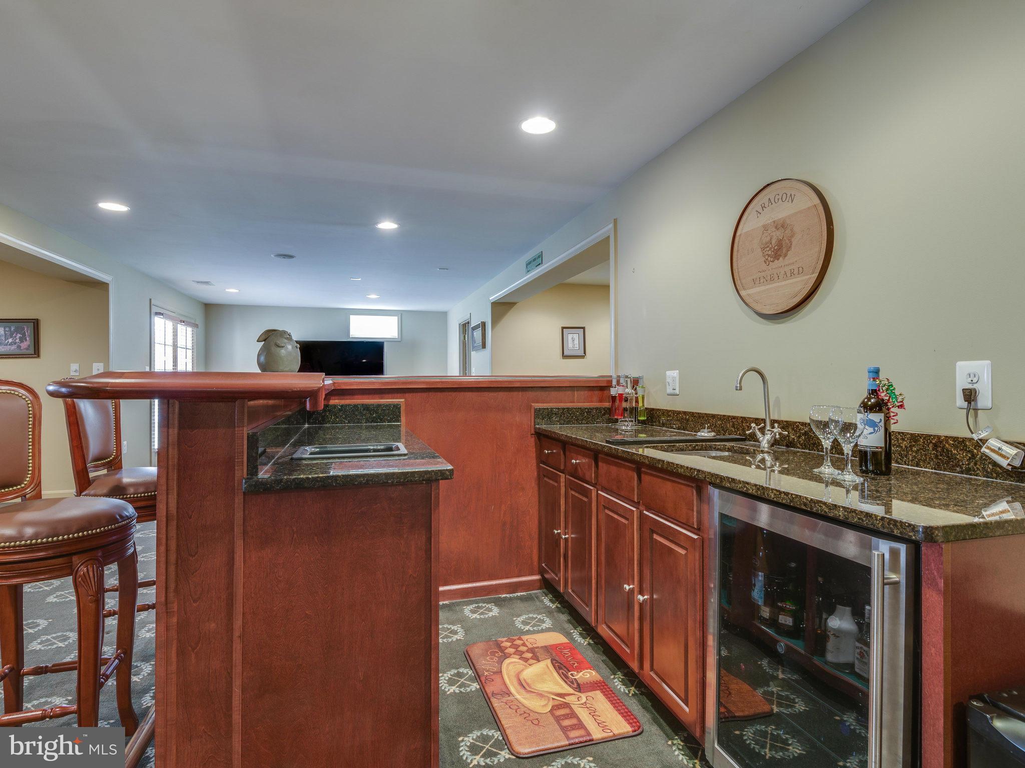 22570 Forest Manor Drive Ashburn, VA 20148 - Photo 23 of 30 a kitchen with stainless steel appliances granite countertop a sink and a stove