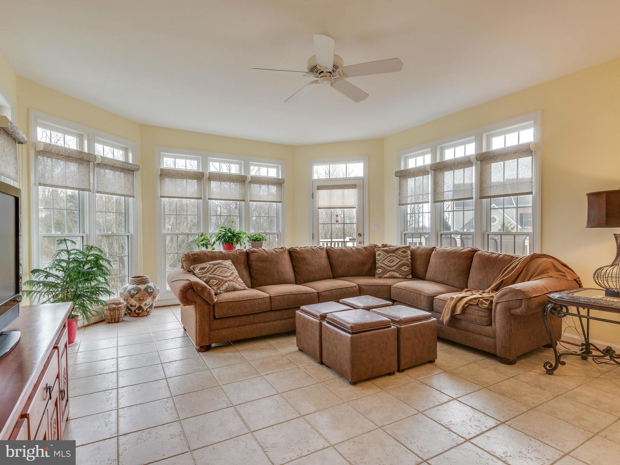 22570 Forest Manor Drive Ashburn, VA 20148 - Photo 10 of 30 a living room with furniture potted plant and a large window