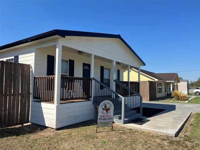 a view of a small space with wooden floor and a window