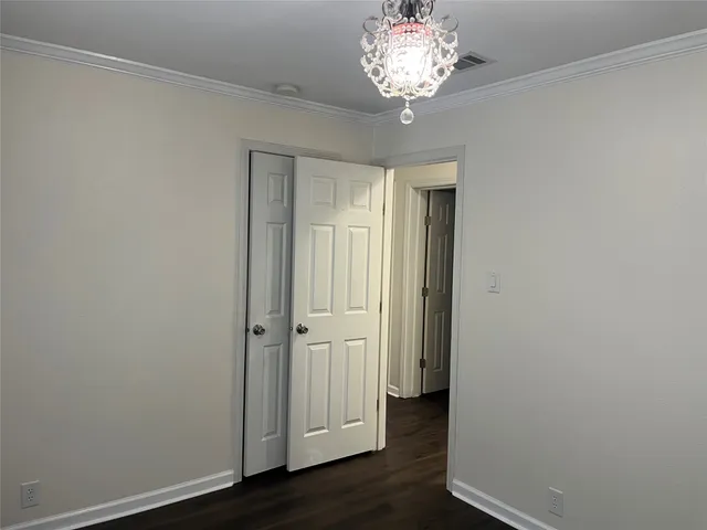 a view of a backyard with floor to ceiling window and outdoor kitchen