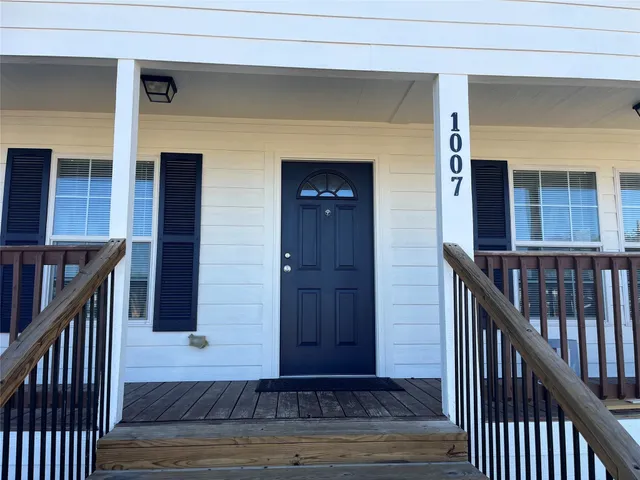 a view of a wooden house with a porch