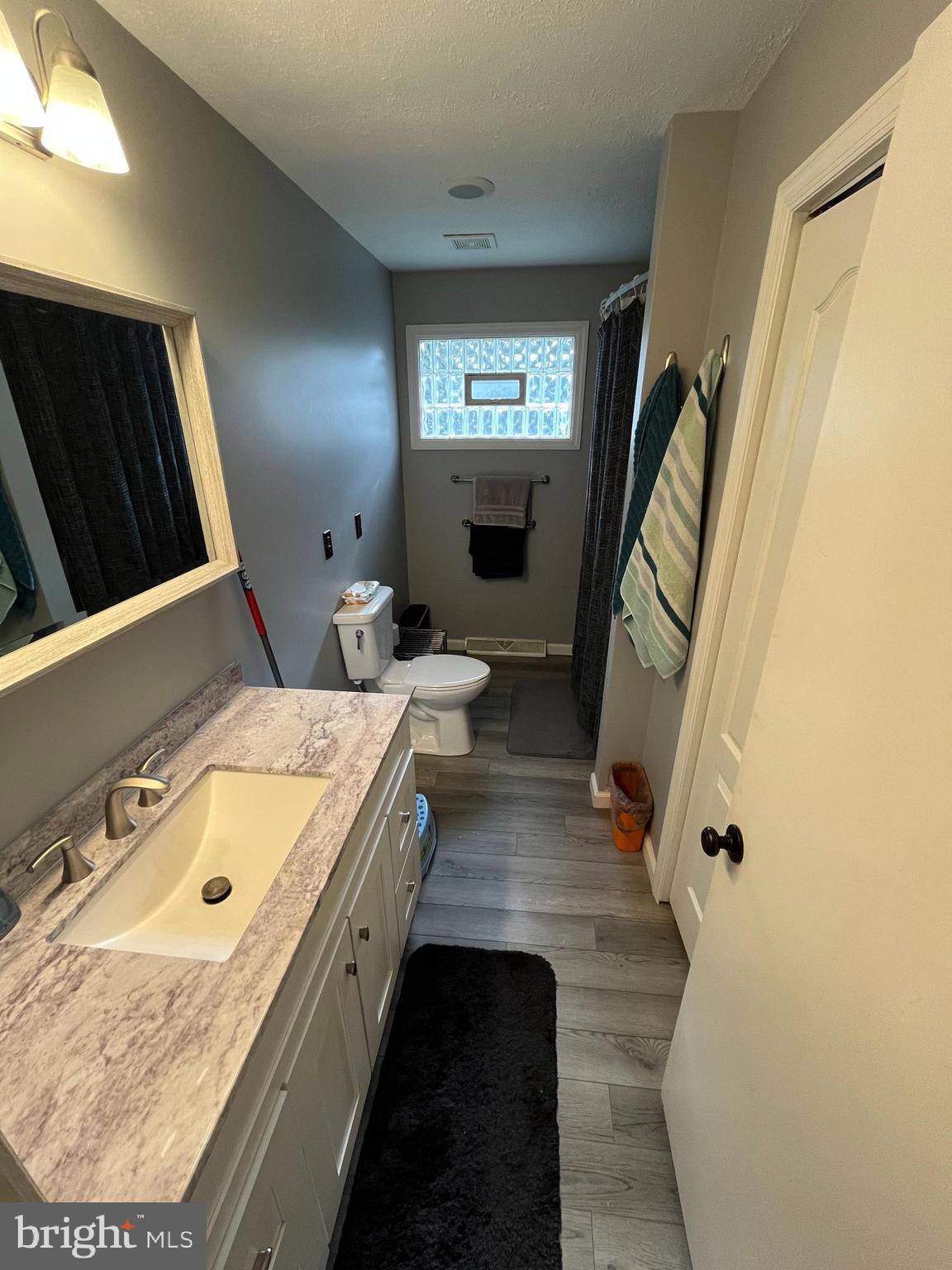 11015 Mexico Farm Road Southeast Cumberland, MD 21502 - Photo 11 of 23 a bathroom with a tub sink and mirror