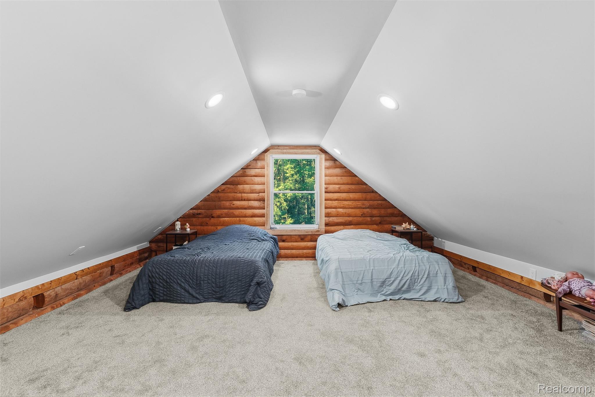 3656 Stanley Road Columbiaville, MI 48421 - Photo 30 of 65 Lofted space featuring angled white ceilings with recessed lighting, wood-finish paneling, and light-colored carpeting