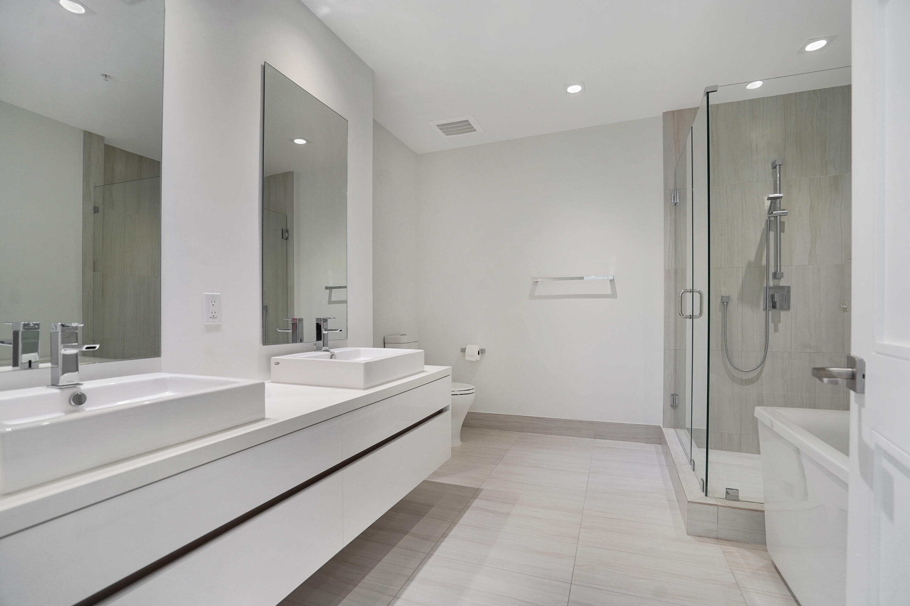 155 East Boca Raton Road, Unit 816 Boca Raton, FL 33432 - Photo 12 of 60 a spacious bathroom with a double vanity sink mirror and shower