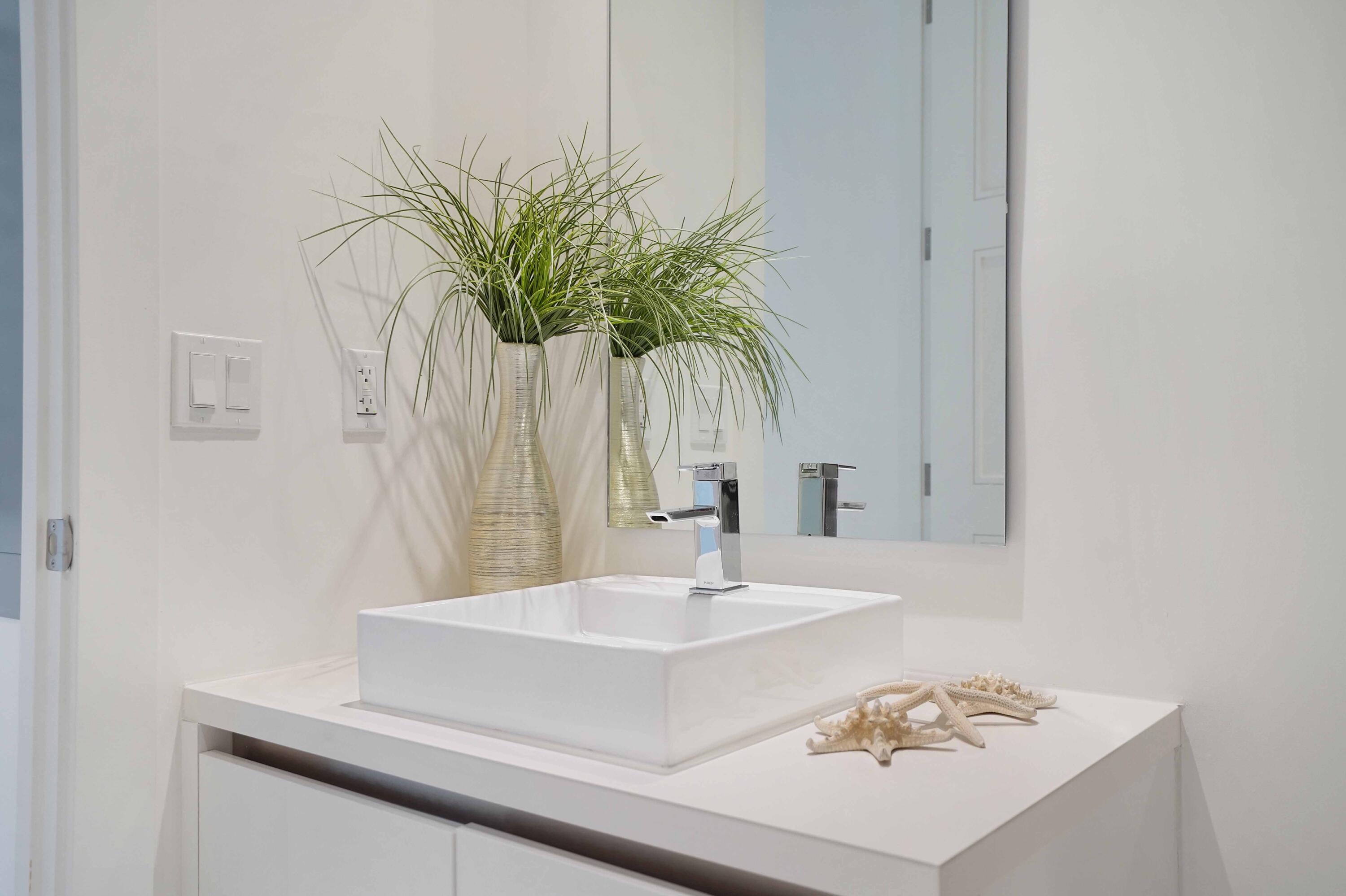 155 East Boca Raton Road, Unit 816 Boca Raton, FL 33432 - Photo 33 of 60 a bathroom with a sink a mirror and a potted plant