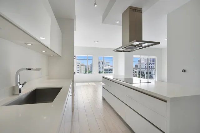 a kitchen with stainless steel appliances a sink and cabinets