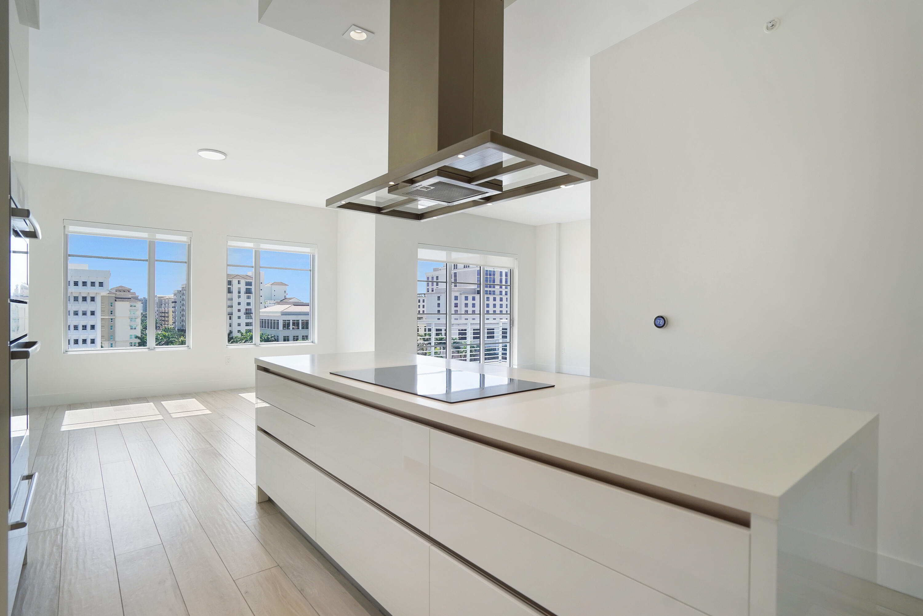 155 East Boca Raton Road, Unit 816 Boca Raton, FL 33432 - Photo 5 of 60 a kitchen with stainless steel appliances granite countertop a sink dishwasher a stove and white countertops with wooden floor