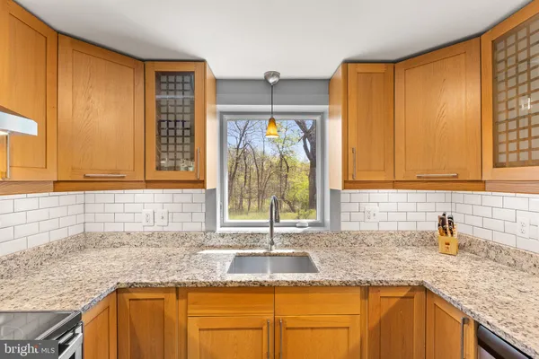 a kitchen with granite countertop a sink and a window