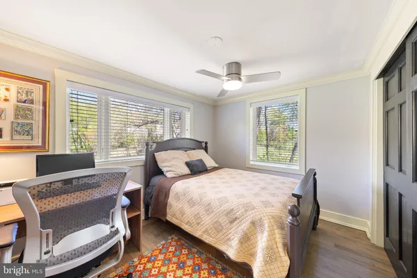 a bedroom with a bed and a desk