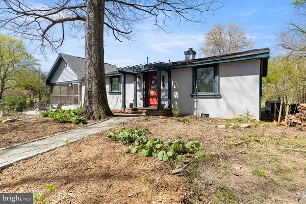 a front view of a house with a tree