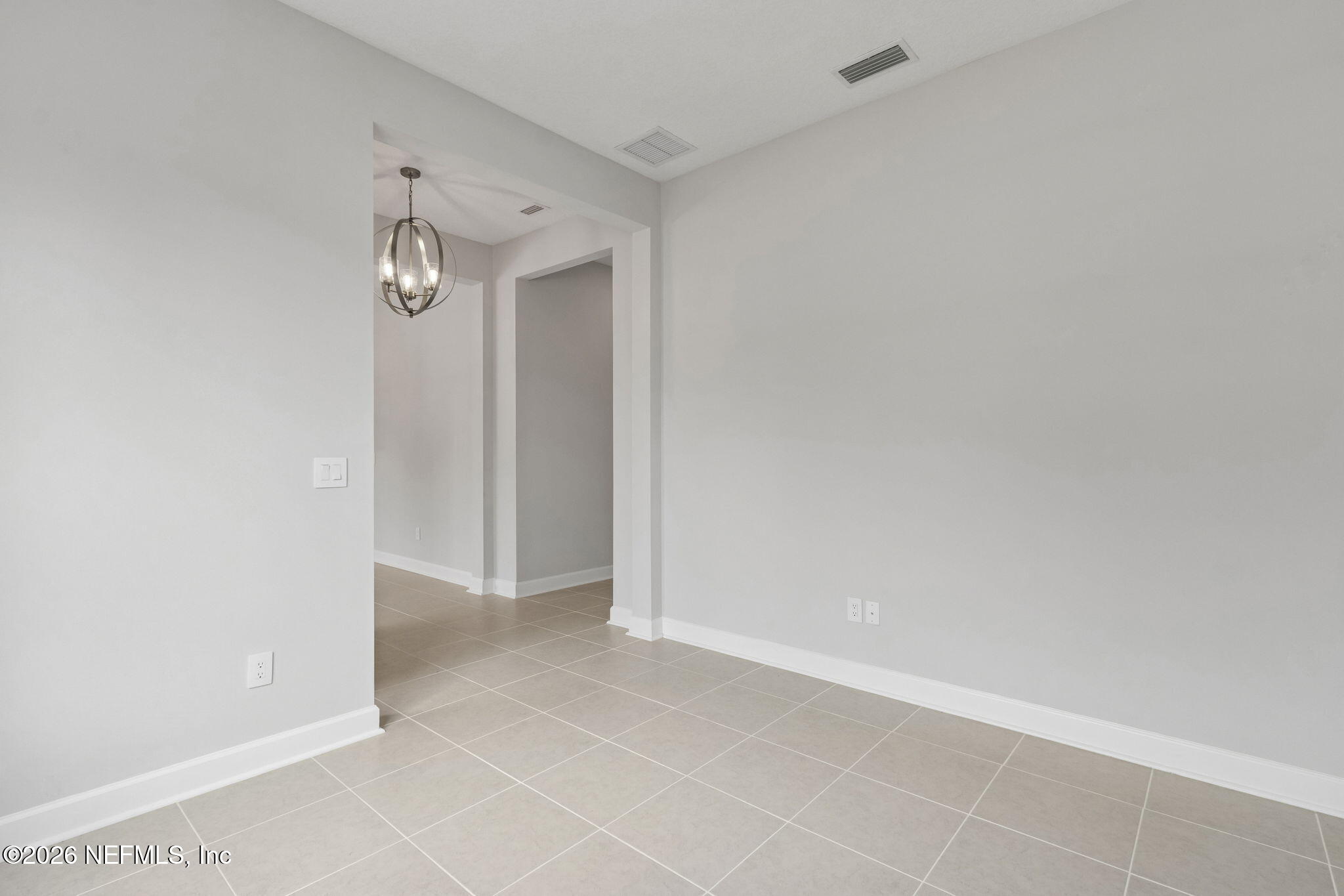 85321 Sandy Rdg Loop Yulee, FL 32097 - Photo 10 of 49 an empty room with a chandelier fan and windows