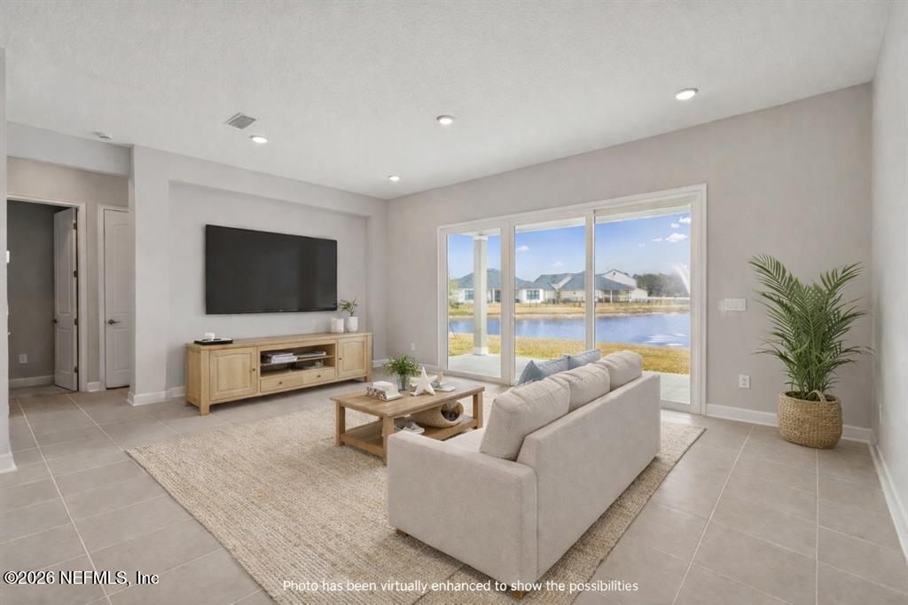85321 Sandy Rdg Loop Yulee, FL 32097 - Photo 2 of 49 a living room with furniture and a flat screen tv