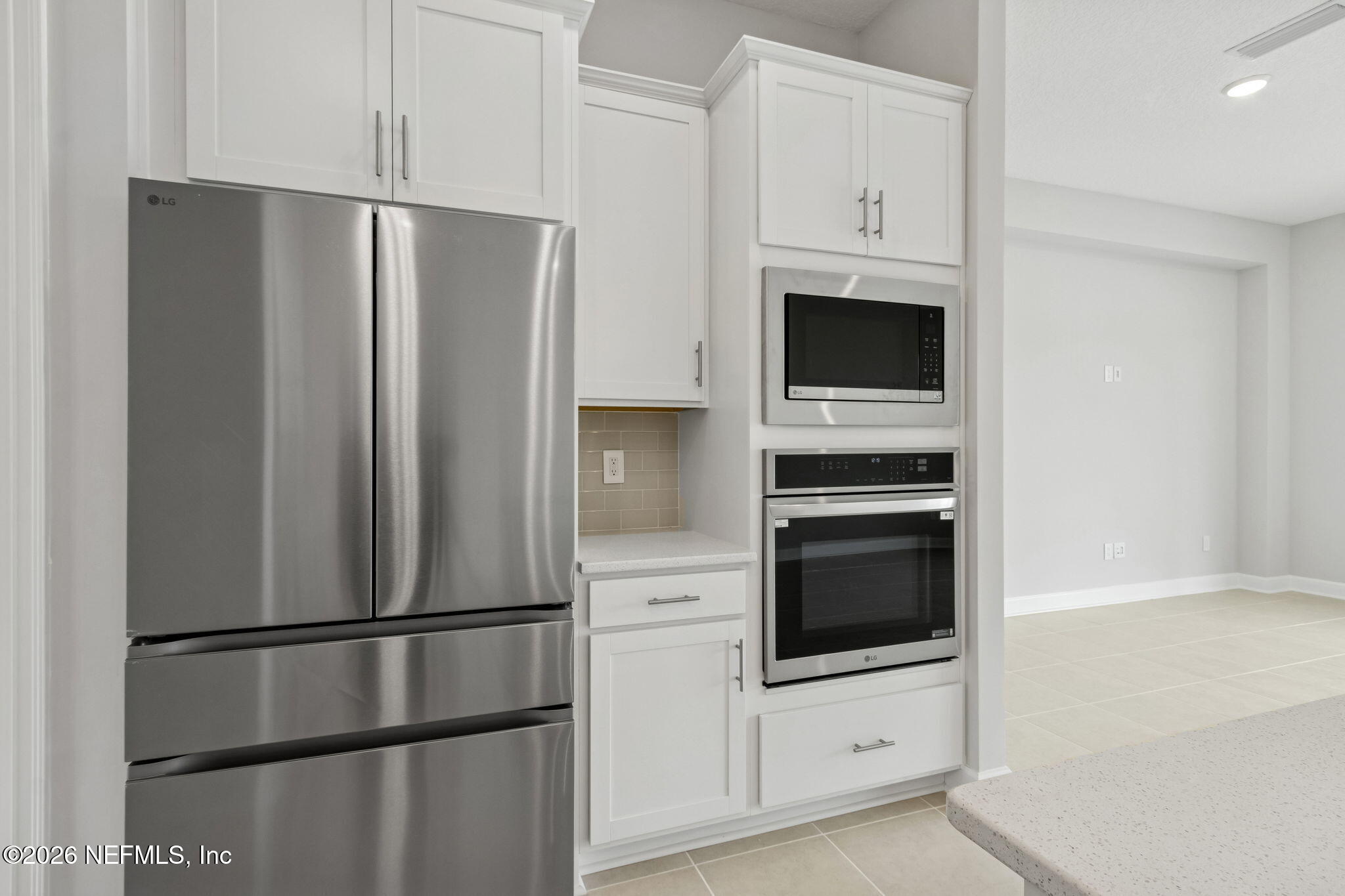 85321 Sandy Rdg Loop Yulee, FL 32097 - Photo 19 of 49 a kitchen with stainless steel appliances white cabinets and a refrigerator