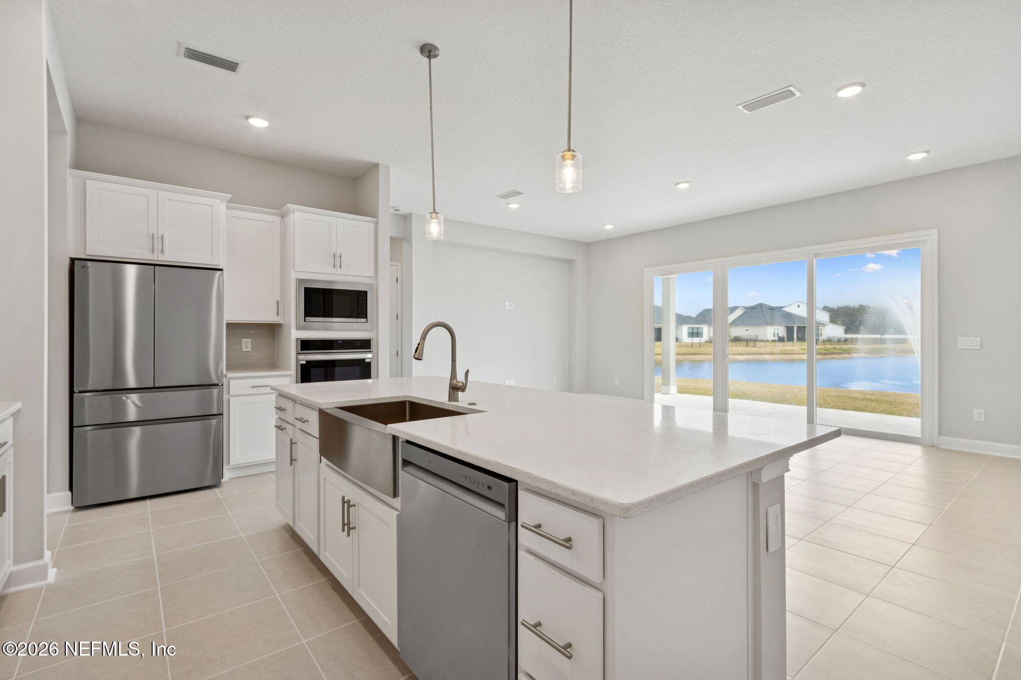 85321 Sandy Rdg Loop Yulee, FL 32097 - Photo 20 of 49 a kitchen with a refrigerator a sink and microwave