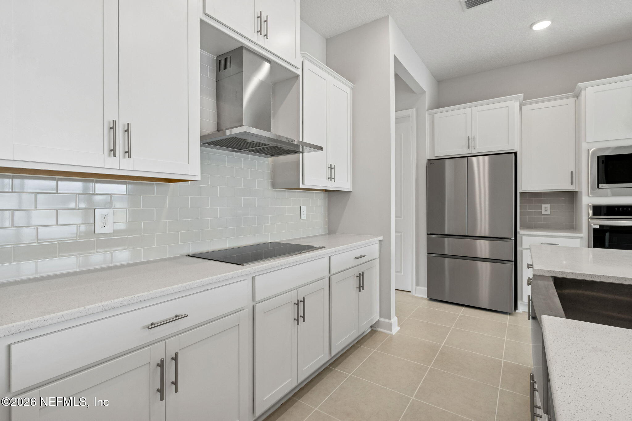 85321 Sandy Rdg Loop Yulee, FL 32097 - Photo 21 of 49 a kitchen with stainless steel appliances a refrigerator sink and cabinets