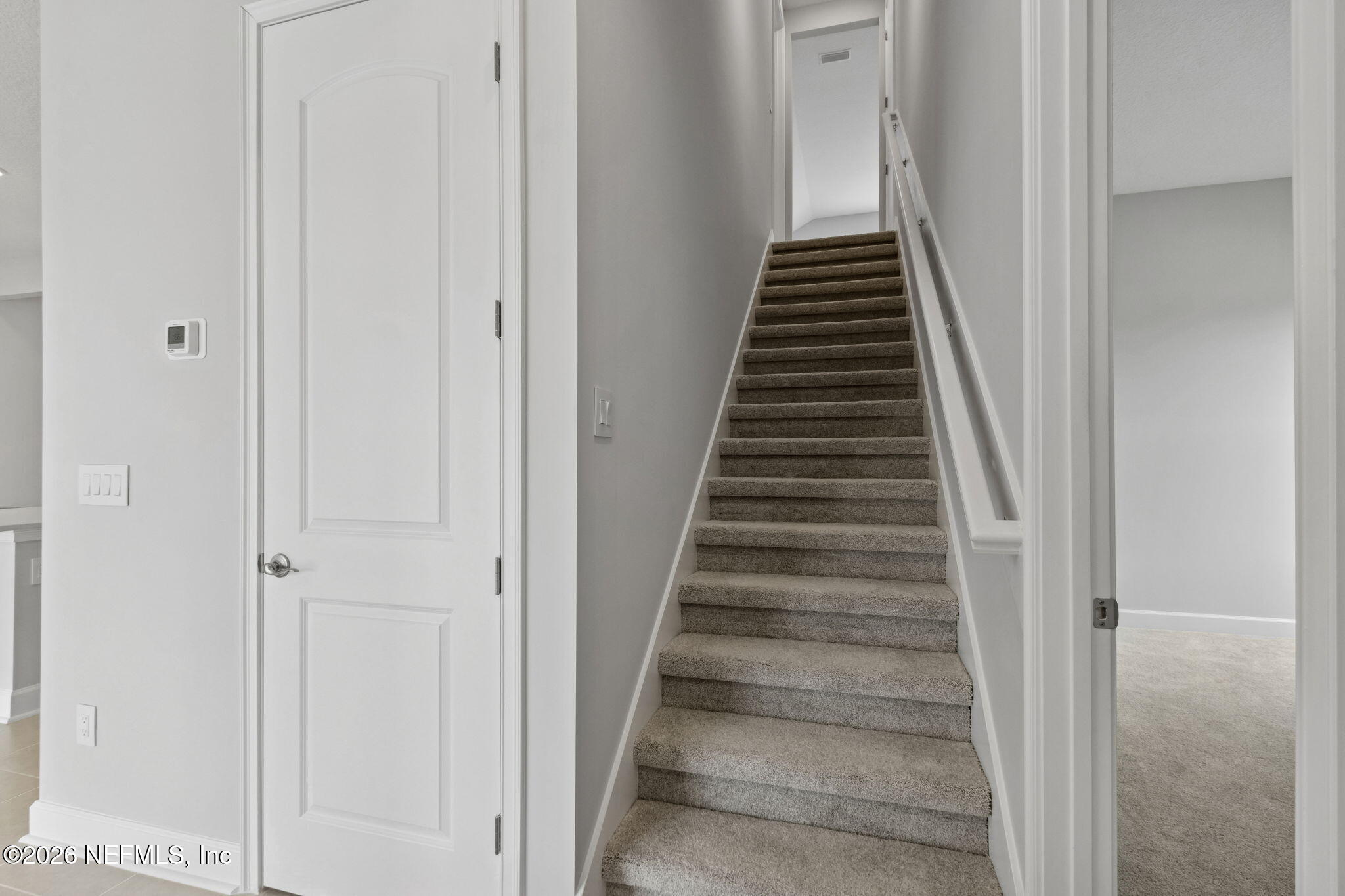 85321 Sandy Rdg Loop Yulee, FL 32097 - Photo 35 of 49 a view of a hallway with wooden staircase