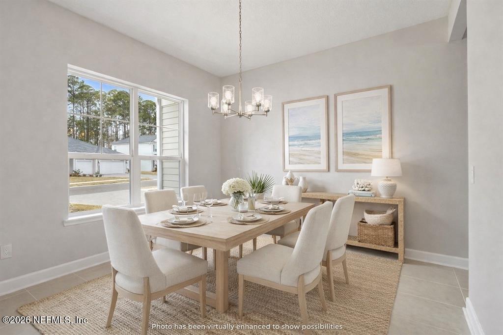 85321 Sandy Rdg Loop Yulee, FL 32097 - Photo 4 of 49 a dining room with furniture a chandelier and wooden floor