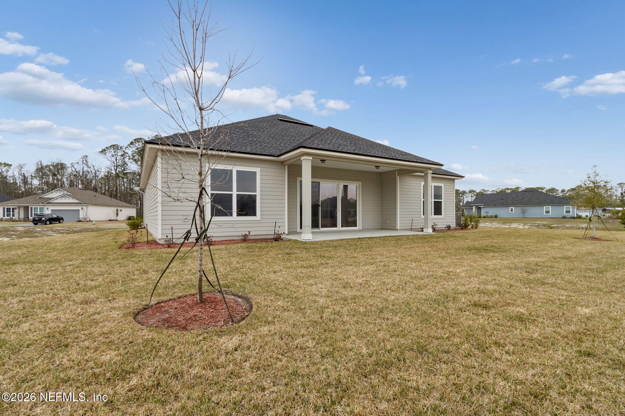 85321 Sandy Rdg Loop Yulee, FL 32097 - Photo 45 of 49 a front view of a house with a yard