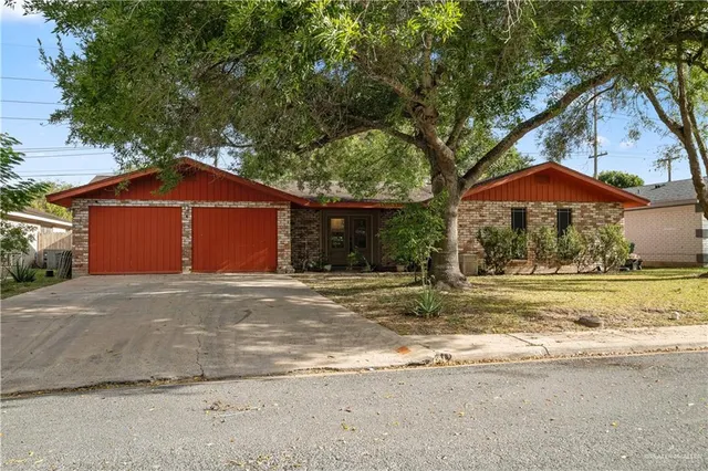 a house with a yard and large trees