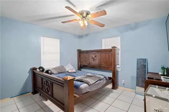 a bedroom with furniture and a ceiling fan