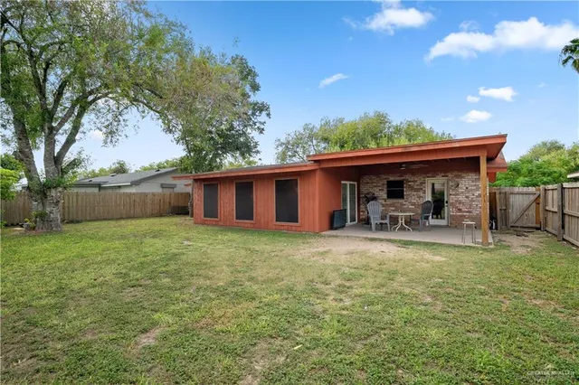 a view of a house with backyard and sitting area