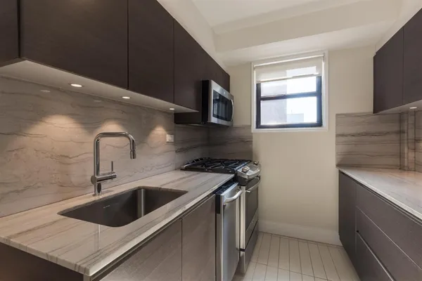 a kitchen that has a sink and a stove