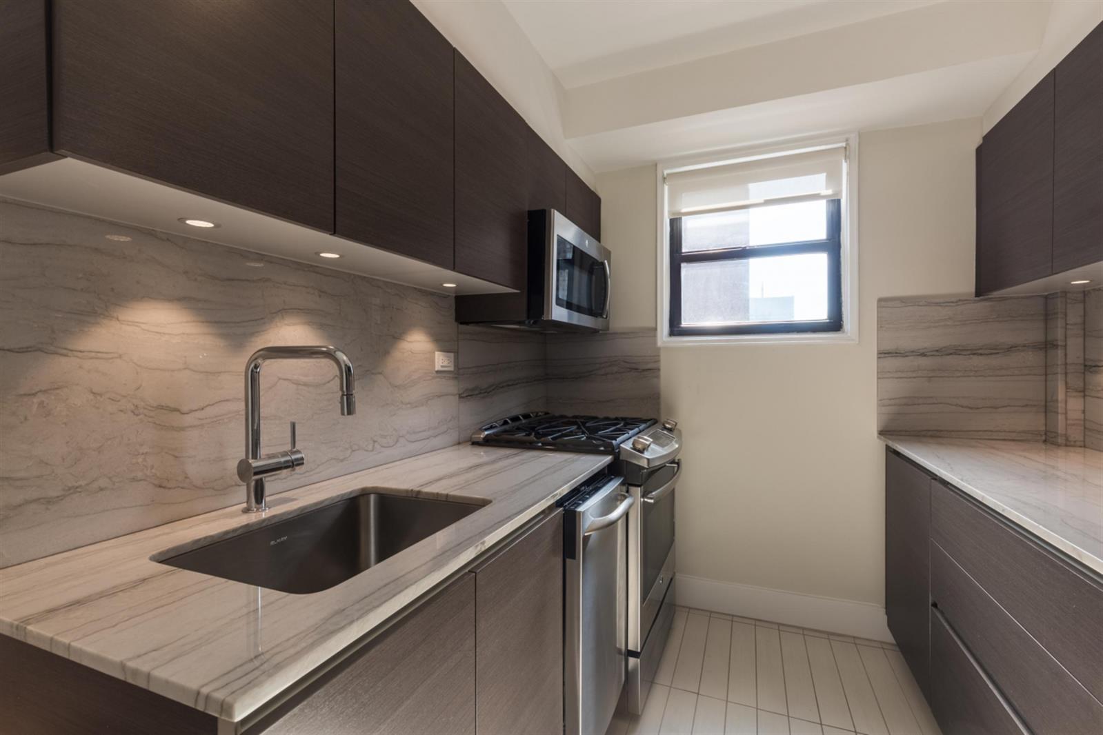 141 East 33rd Street, Unit 4B Manhattan, NY 10016 - Photo 3 of 9 a kitchen that has a sink and a stove