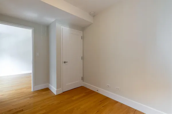 a view of an empty room and wooden floor