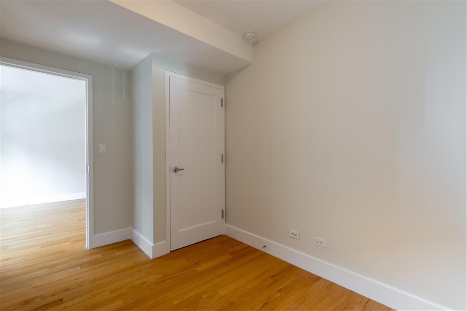 141 East 33rd Street, Unit 4B Manhattan, NY 10016 - Photo 8 of 9 a view of an empty room and wooden floor