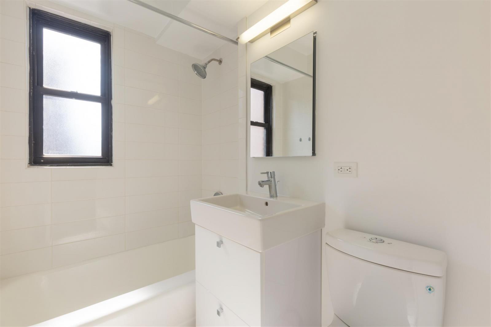 141 East 33rd Street, Unit 4B Manhattan, NY 10016 - Photo 9 of 9 a bathroom with a sink a toilet and shower