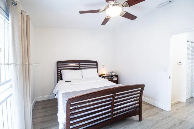 a bedroom with a bed and a window